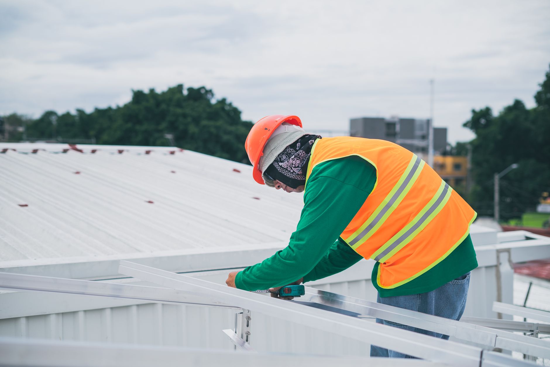 A close-up of a roofer expertly installing drip edge flashing on a Quincy home, ensuring proper water runoff and protection against coastal elements.