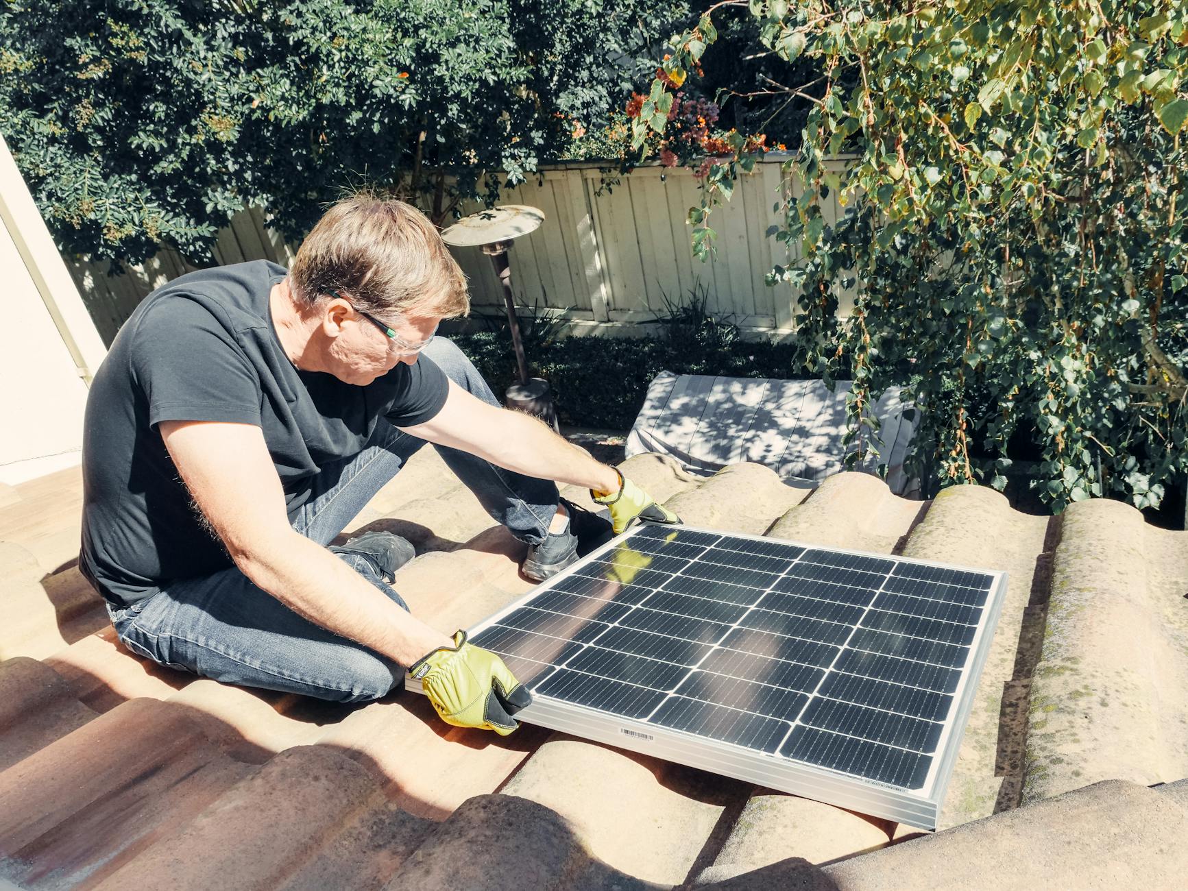 A close-up of a GAF certified roofer from Iron Star Roofing explaining shingle options to a homeowner in front of a Holbrook residence, demonstrating clear communication.